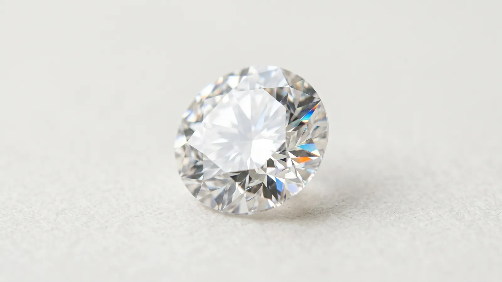 Macro photograph of a round brilliant diamond showing light dispersion across its facets